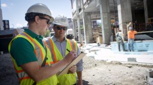 Two men at building construction site.